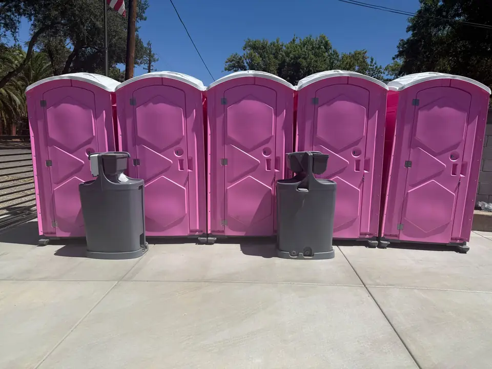 Pink event porta potties with hand-wash stations, the kind of unit delivered in Broken Arrow