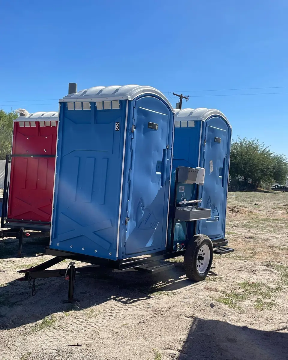 Towable trailer carrying porta potties
